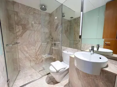 a bathroom with a toilet and a sink and a shower at Resort Living 2BR - Ultra Fast Wifii - BTS Chong Nonsi in Bangkok