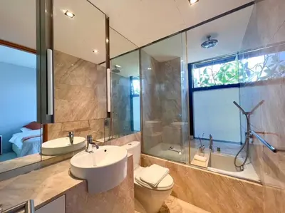 a bathroom with a sink and a toilet and a shower at Resort Living 2BR - Ultra Fast Wifii - BTS Chong Nonsi in Bangkok