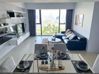 a living room with a couch and a table at Resort Living 2BR - Ultra Fast Wifii - BTS Chong Nonsi in Bangkok