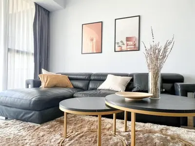 a living room with a couch and a table at Resort Living 2BR - Ultra Fast Wifii - BTS Chong Nonsi in Bangkok
