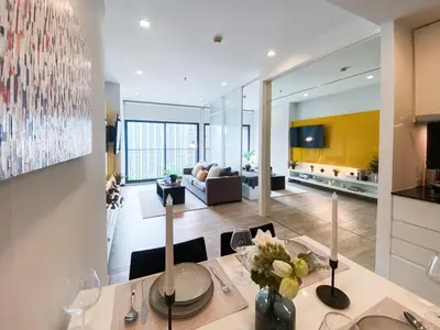 a living room with a dining table and a couch at Deluxe Suite 1BR Ultra Fast WiFi BTS Thong Lor in Bangkok
