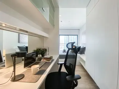 a living room with a chair and a desk at Deluxe Suite 1BR Ultra Fast WiFi BTS Thong Lor in Bangkok