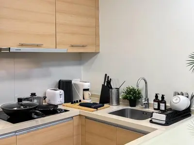 a kitchen with a sink and a counter top at Expansive Luxury 2BR - Ultra Fast Wifi - Phrom Phong in Bangkok