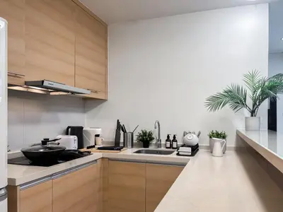 a kitchen with a sink and a counter top at Expansive Luxury 2BR - Ultra Fast Wifi - Phrom Phong in Bangkok