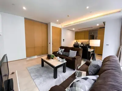 a living room with a couch and a table at Transquil Residents 65 SQM - Ultra Fast Wifi - Silom in Bangkok