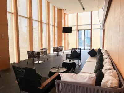a living room with a couch and chairs and tables at Transquil Residents 65 SQM - Ultra Fast Wifi - Silom in Bangkok