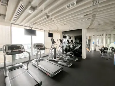 a gym with cardio equipment in a large room at Stylish Riverview 1BR - Ultra Fast WiFi - Phrom Phong in Bangkok