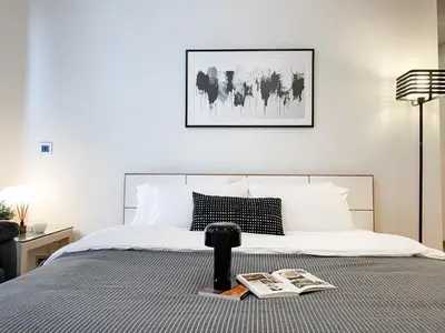 a bedroom with a bed with a book on it at Extravagant Apt 65 sqm 1BR - Ultra Fast Wifi - Silom in Bangkok