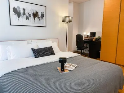 a bedroom with a bed with a desk and a book at Extravagant Apt 65 sqm 1BR - Ultra Fast Wifi - Silom in Bangkok