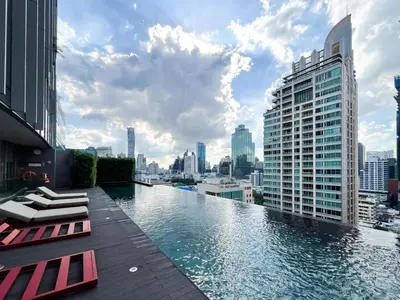a pool on the roof of a building with a city at Extravagant Apt 65 sqm 1BR - Ultra Fast Wifi - Silom in Bangkok