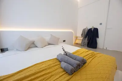 a bedroom with a bed with two pillows on it at Ratchada Retreat Boutique Suites in Bangkok