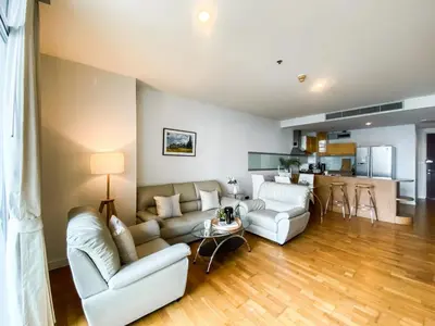 a living room with two couches and a kitchen at Downtown View 65 SQM - Ultra Fast Wifi - Sathorn in Bangkok