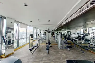 a gym with treadmills and machines in a building at Stylish Modern 1BR - BTS Phrom Phong - Ultra Fast WiFi in Bangkok