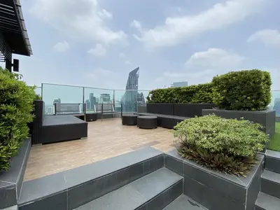 a rooftop patio with a view of the city at Stylish Modern 1BR - BTS Phrom Phong - Ultra Fast WiFi in Bangkok