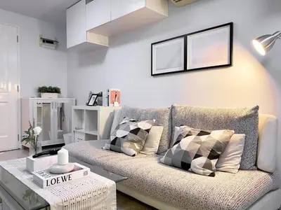 a living room with a couch and a table at Exclusive Modern Apt - Ultra Fast WiFi - Thong Lo in Bangkok