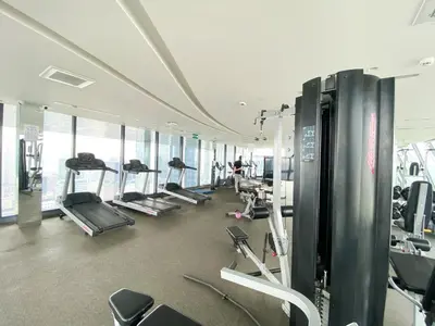 a gym with treadmills and machines in a building at Luxury Skyview 1BR - Ultra Fast WiFi - Chit Lom in Bangkok