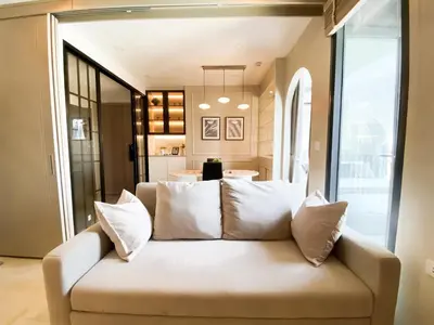 a living room with a couch with pillows at Luxury Skyview 1BR - Ultra Fast WiFi - Chit Lom in Bangkok