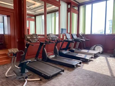 a gym with several treadmills and elliptical machines at Luxury Modern 2BR 145 sqm - BTS Asok - Ultra Fast WiFi in Bangkok