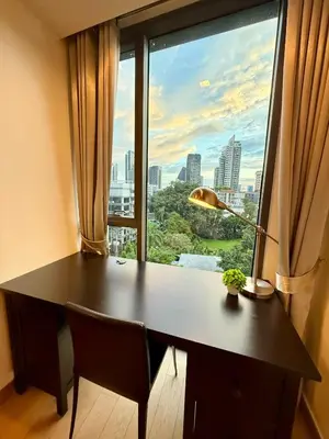 a desk in front of a large window with a view at Cozy Spacious 1BR 3pax GardenView, 700m BTS ThongLo, Samitivej, SKV49, Fast wifi in Bangkok