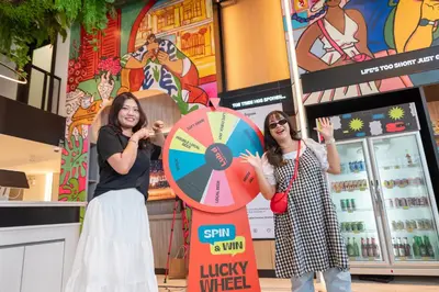 two women standing next to a clock in front of a store at Lub d Bangkok Chinatown - Steps from Sam Yod MRT Station in Bangkok