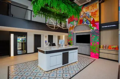 a lobby with a colorful mural on the wall at Lub d Bangkok Chinatown - Steps from Sam Yod MRT Station in Bangkok