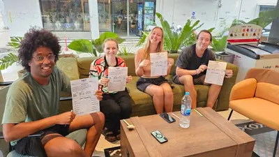 a group of people sitting on a couch holding up certificates at Lub d Bangkok Chinatown - Steps from Sam Yod MRT Station in Bangkok