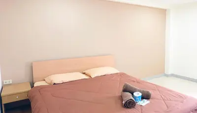 a bedroom with a large bed with two pillows at Grand Residence in Bangkok