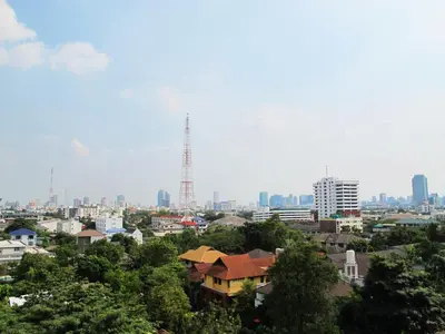 a view of a city with a tower in the distance at Grand Residence in Bangkok