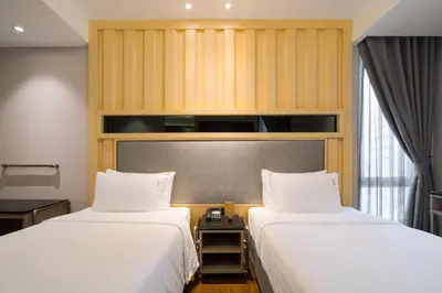 two beds sitting next to each other in a room at T2 The Portal Sukhumvit in Bangkok