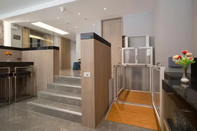 a lobby with stairs and a elevator in a building at T2 The Portal Sukhumvit in Bangkok