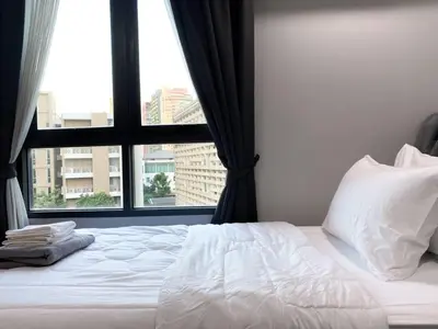 a bedroom with a bed with a large window at 2Br Modern Comfort at Vibrant Asok BTS Station in Bangkok