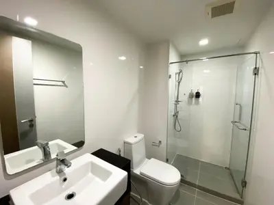 a bathroom with a toilet and a sink and a shower at 2Br Modern Comfort at Vibrant Asok BTS Station in Bangkok