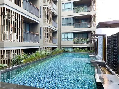a swimming pool in the middle of a building at 2Br Modern Comfort at Vibrant Asok BTS Station in Bangkok