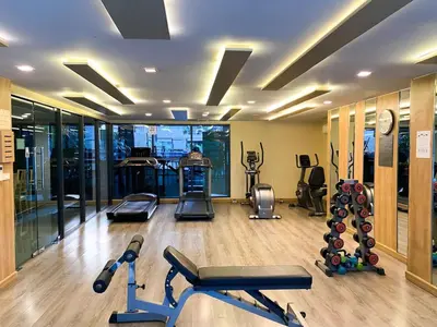 a gym with several exercise equipment in a room at 2Br Modern Comfort at Vibrant Asok BTS Station in Bangkok