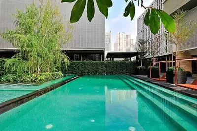 a swimming pool in the middle of a building at The Grand Penthouse 2BR Ultra Fast WiFi Sukhumvit in Bangkok