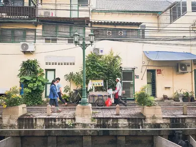 a group of people walking on a bridge at Bangkok Neighborhood Hostel in Bangkok