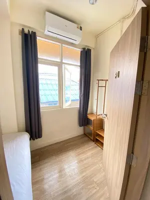a room with a bed and a window at Bangkok Neighborhood Hostel in Bangkok