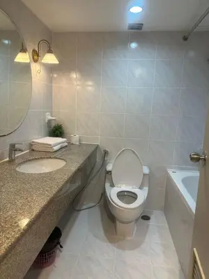 a bathroom with a toilet and a sink and a tub at Rent Omni Tower Apartments Nana Bangkok - Prime Sukhumvit location in Bangkok