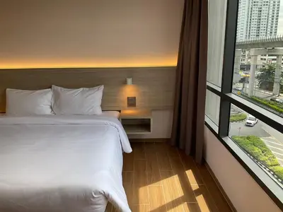 a hotel room with a bed and a large window at 35 Bow Hotel in Ban Bang Bamru