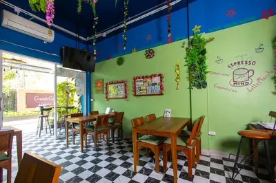 a restaurant with tables and chairs in a room at Tom Guest House ทอมส์ เกสต์เฮ้าส์ in Thung Maha Mek