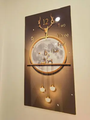 a clock hanging on a wall in a room at Vevey Mansion in Bangkok
