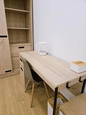 a wooden desk in a room with a chair at Vevey Mansion in Bangkok
