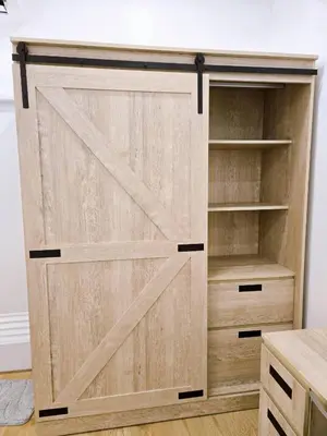a wooden closet with a sliding door at Vevey Mansion in Bangkok