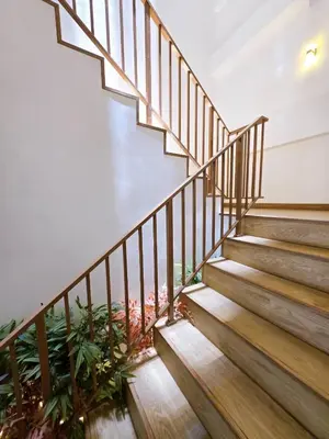 a staircase in a house with wooden treads at Vevey Mansion in Bangkok