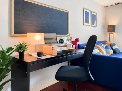 a desk with a laptop and a chair in a room at Contemporary 53 SQM - BTS Thong Lo - Ultra Fast WiFi in Bangkok