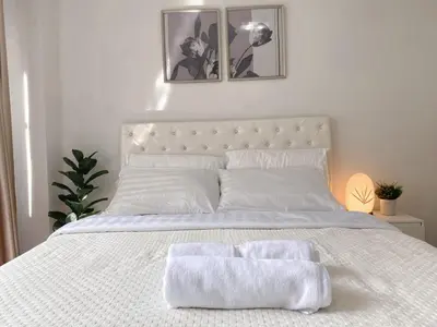 a white bed with two white towels on it at Contemporary 53 SQM - BTS Thong Lo - Ultra Fast WiFi in Bangkok