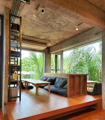 a living room with a couch and a table at Hiddenwoods in Bang Chak