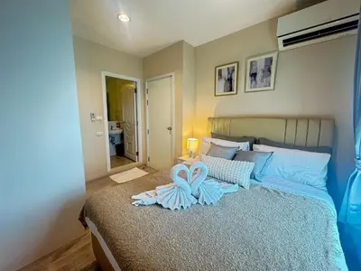 a bedroom with a bed with two towels on it at Minimal 2 BR next to IKEA, Central Westgate Bangyai in Ban Bang Krabu