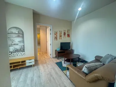 a living room with a couch and a television at Minimal 2 BR next to IKEA, Central Westgate Bangyai in Ban Bang Krabu