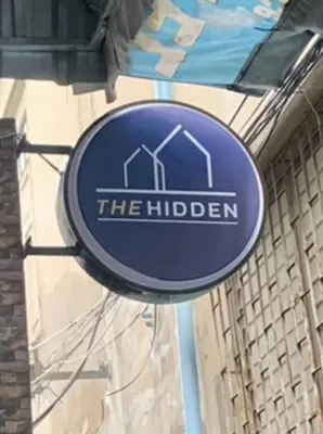 a blue sign that reads the huden on a building at xx The Hidden Sao Chingcha - เดอะ ฮิดเด้น เสาชิงช้า in Bangkok